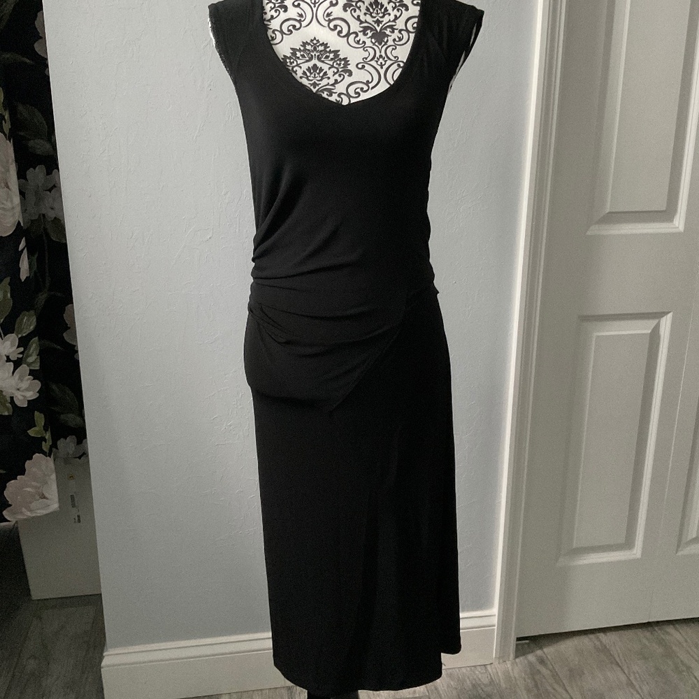 Sleeveless black dress with  attached belt to make bow.